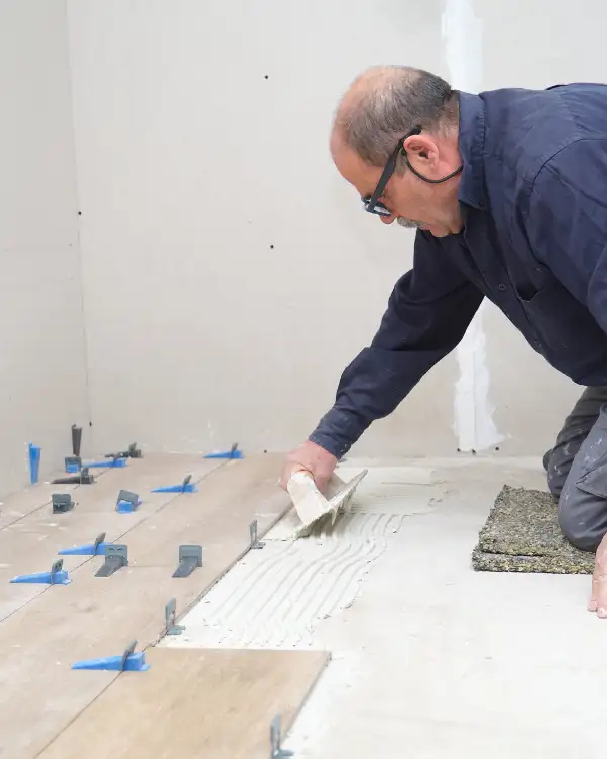 Professional roofing contractor laying tiles on a Greater Manchester home roof